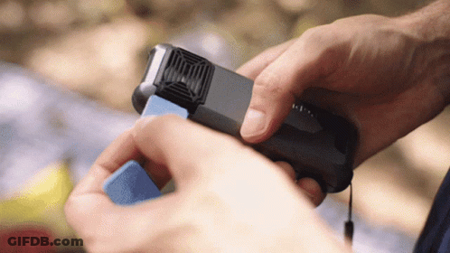 A Person Is Holding A Small Device That Says ' I ' On It GIF