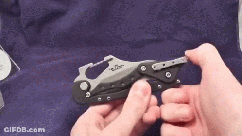 A Person Is Holding A Small Knife In Their Hands . GIF