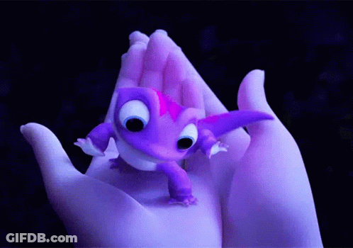 A Person Is Holding A Small Purple Lizard In Their Hand GIF