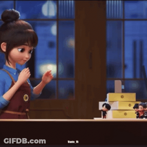 A Person Is Holding A Small Toy In Their Hand . GIF