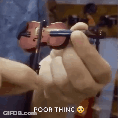 A Person Is Holding A Small Violin In Their Hand With The Caption Poor Thing . GIF