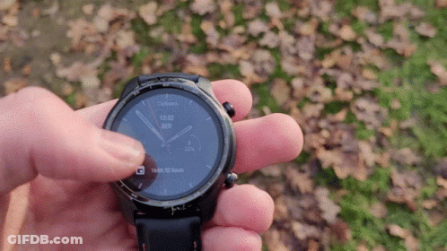 A Person Is Holding A Smart Watch In Their Hand And It Shows The Time As 13:53 GIF