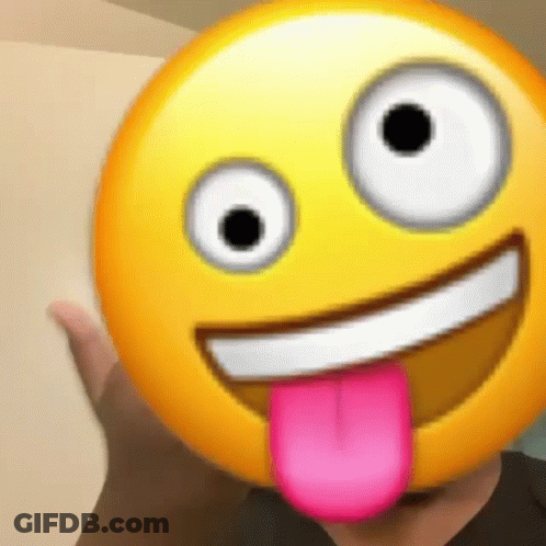 A Person Is Holding A Smiley Face With A Pink Tongue Sticking Out Of It . GIF