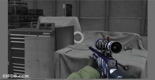 A Person Is Holding A Sniper Rifle In A Room With Boxes In The Background And A Sniper Scope On The Wall GIF