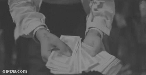 A Person Is Holding A Stack Of Money In Their Hands . GIF