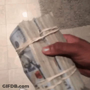 A Person Is Holding A Stack Of Money Wrapped In String . GIF