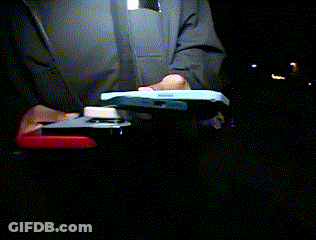 A Person Is Holding A Stapler And A Cell Phone GIF
