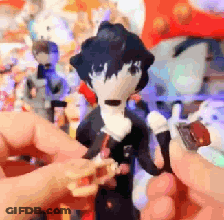 A Person Is Holding A Stuffed Animal In Their Hand In Front Of A Bunch Of Stuffed Animals . GIF