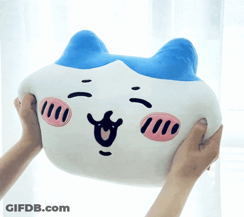 A Person Is Holding A Stuffed Animal That Looks Like A Pig GIF