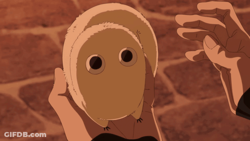 A Person Is Holding A Stuffed Animal With A Face On It GIF