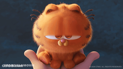 A Person Is Holding A Stuffed Garfield Cat GIF