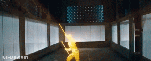 A Person Is Holding A Sword In A Room With A Lot Of Windows And Lights . GIF
