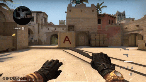 A Person Is Holding A Sword In Front Of A Block That Says A On It GIF