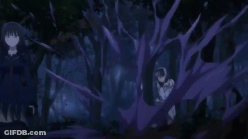 A Person Is Holding A Sword In Their Hand In A Dark Room . GIF