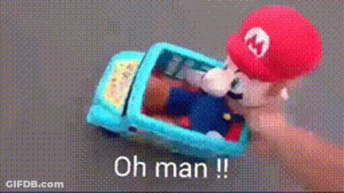 A Person Is Holding A Toy Mario In A Car With The Words Oh Man Written On The Bottom GIF