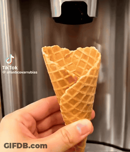 A Person Is Holding A Waffle Cone With Tiktok Written On It GIF
