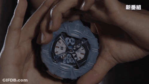 A Person Is Holding A Watch That Says Texu On The Face GIF