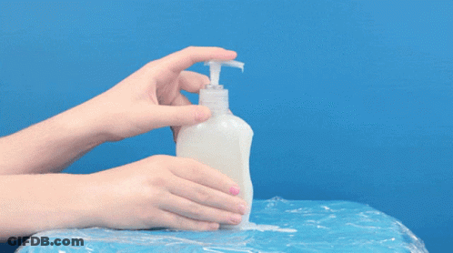 A Person Is Holding A White Bottle With A Hose Attached To It GIF
