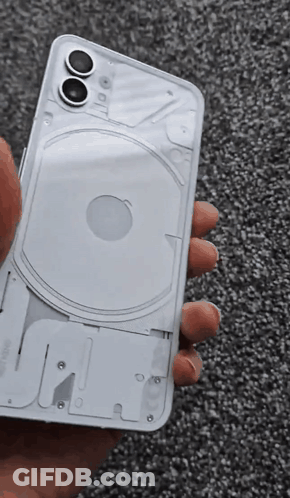 A Person Is Holding A White Iphone That Has The Back Removed GIF