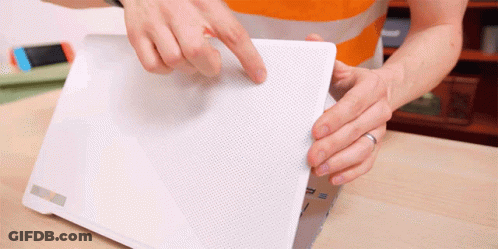 A Person Is Holding A White Laptop With The Letter P On The Back GIF