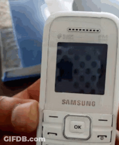 A Person Is Holding A White Samsung Phone GIF