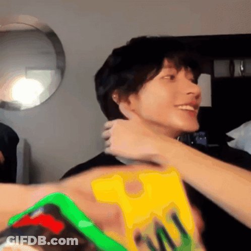 Person Holding Yellow M & M Item GIF