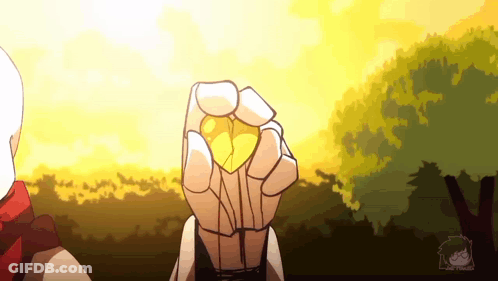 A Person Is Holding A Yellow Object In Their Hand In Front Of A Sunset . GIF