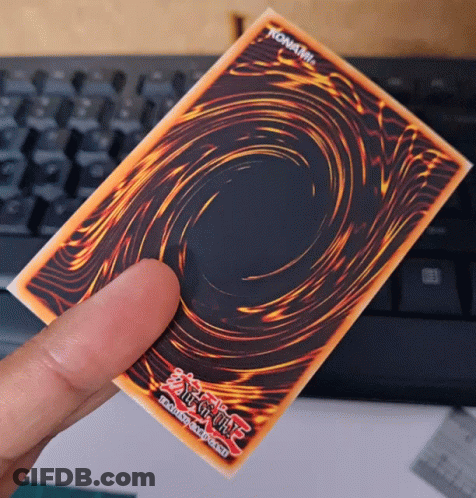 A Person Is Holding A Yu Gi Oh Card In Their Hand GIF