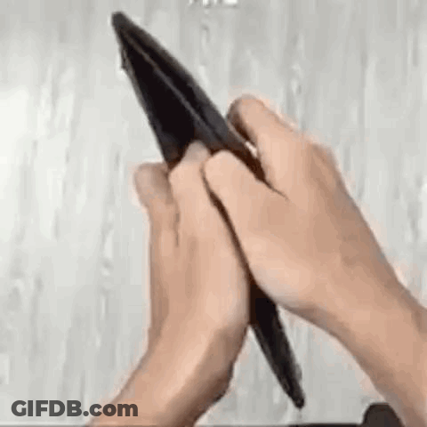A Person Is Holding An Empty Wallet With Their Hands . GIF