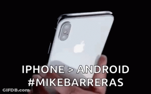 A Person Is Holding An Iphone In Their Hand With The Words Iphone > Android #Mikebarrieras Written On It . GIF