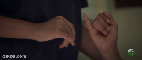 A Person Is Holding Another Person 'S Finger And The Words Project Exit Are On The Bottom GIF