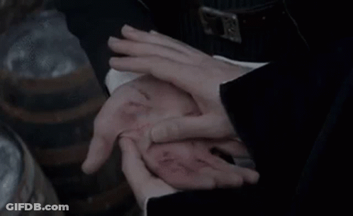 A Person Is Holding Another Person 'S Hand With A Wound In It . GIF