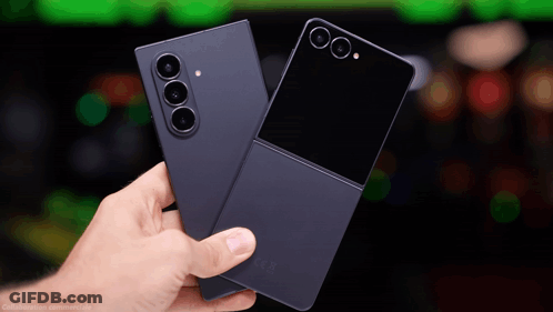 A Person Is Holding Two Cell Phones One Of Which Is A Samsung Flip Phone GIF