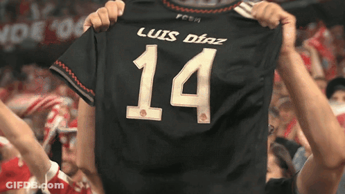 A Person Is Holding Up A Jersey That Says Luis Diaz 14 GIF