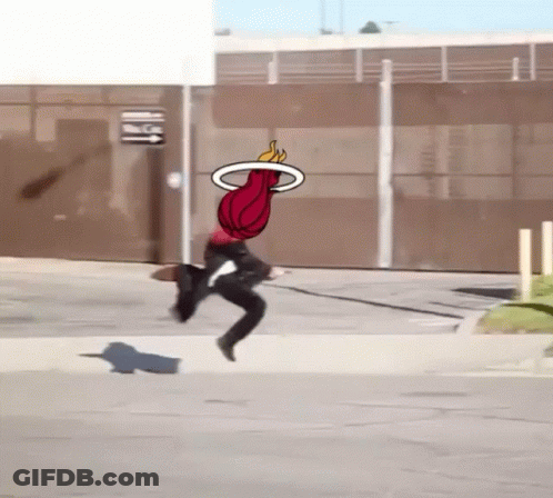 A Person Is Jumping In The Air With A Basketball In The Air GIF
