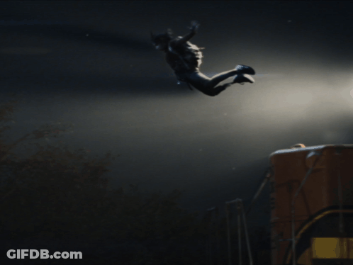 A Person Is Jumping In The Air With A Dark Background GIF