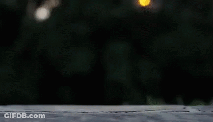 A Person Is Jumping In The Air With A Pair Of White Sneakers . GIF