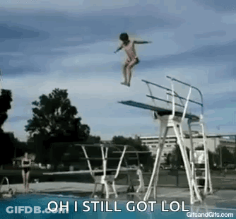 A Person Is Jumping Off Of A Diving Board Into A Pool . GIF