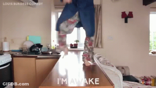 A Person Is Jumping On A Counter With The Words I 'M Awake On It GIF