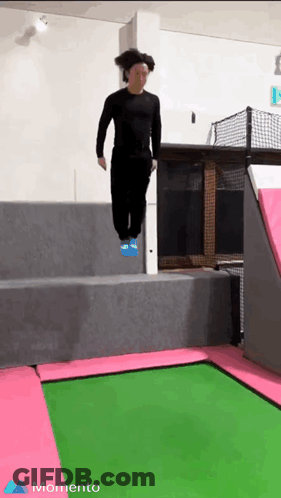 A Person Is Jumping On A Green And Pink Trampoline With The Word Momento In The Corner GIF