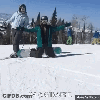 A Person Is Kneeling Down On A Snowboard In The Snow While Another Person Stands Behind Them . GIF