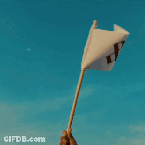 A Person Is Kneeling On The Beach Playing In The Sand GIF