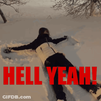A Person Is Laying In The Snow With The Words Hell Yeah Written In Red GIF