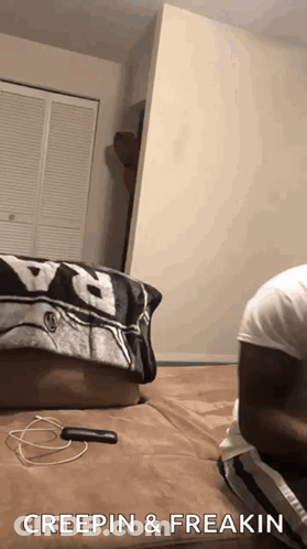 A Person Is Laying On A Bed With The Words Creepin & Freakin Written On The Bottom . GIF