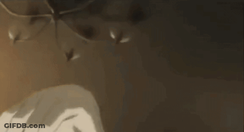A Person Is Laying On A Bed With Their Head On Another Person 'S Shoulders . GIF