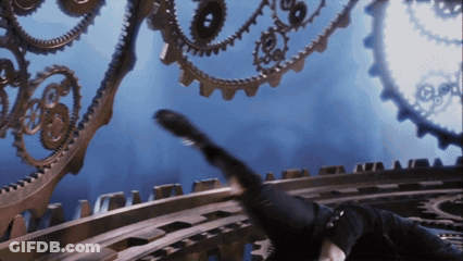 A Person Is Laying On A Staircase With Gears Behind Them GIF