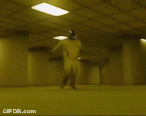 A Person Is Laying On The Floor In A Dark Room With A Yellow Ceiling . GIF