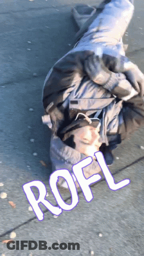 A Person Is Laying On The Ground With The Word Rofl Written On The Sidewalk GIF