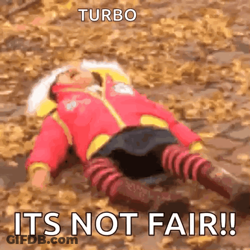 A Person Is Laying On The Ground With The Words Turbo Its Not Fair GIF