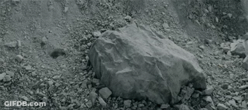A Person Is Laying On The Ground With Their Head On Another Person 'S Knee . GIF